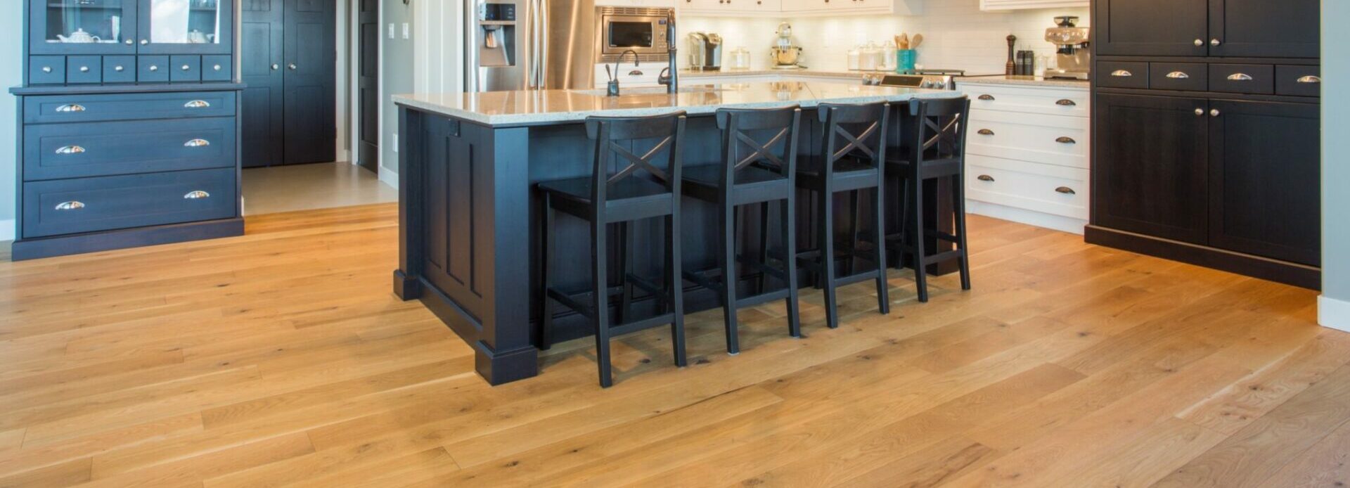A brightly-lit kitchen with hardwood flooring