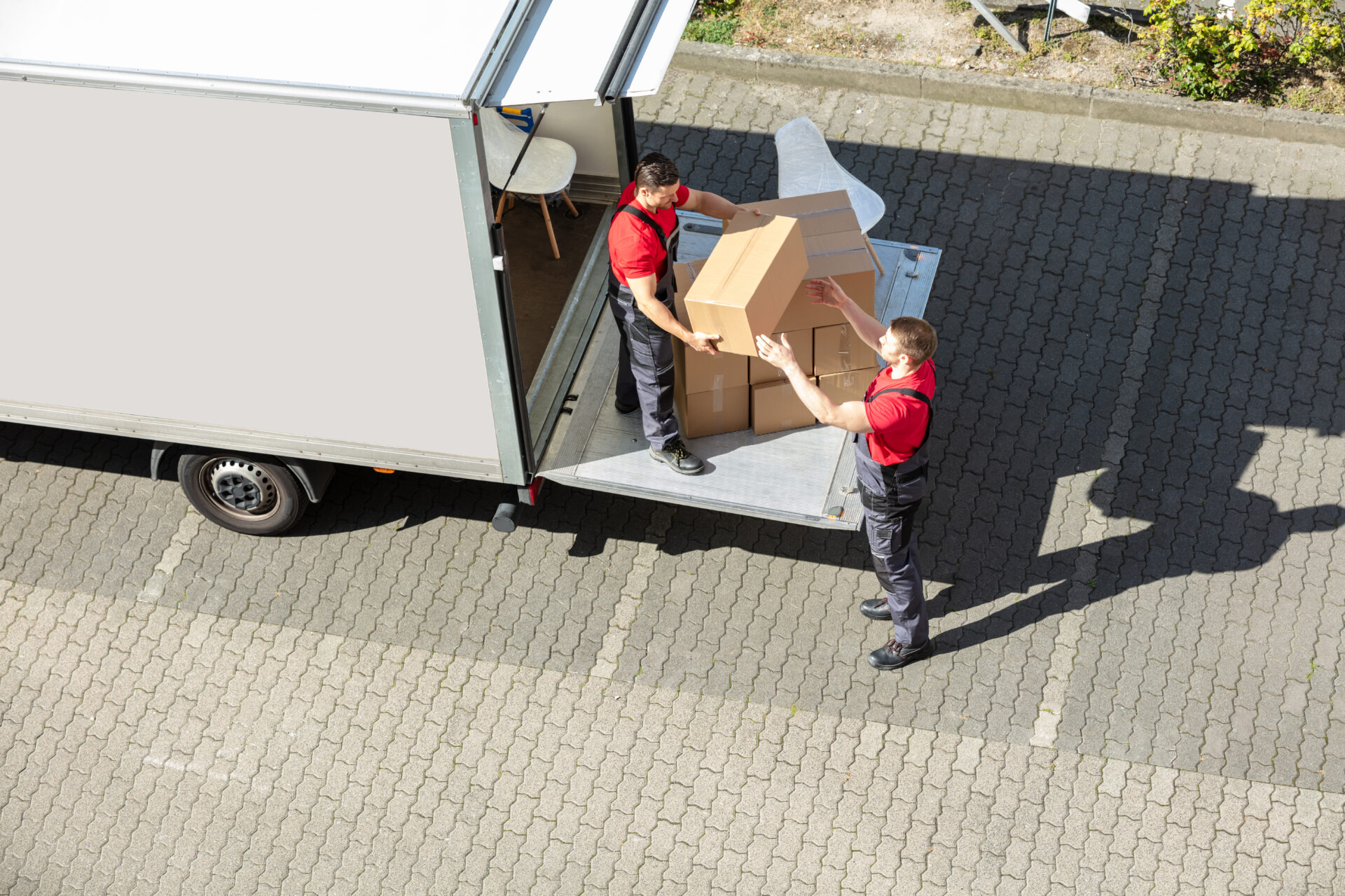 professional movers unloading boxes from a moving truck