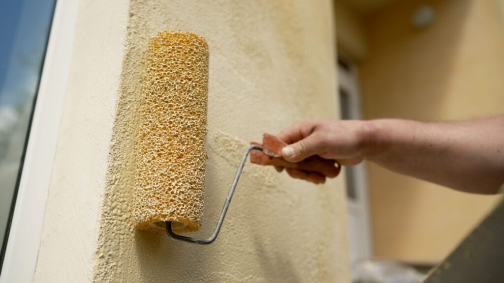 Close-up of a painter using a paint roller