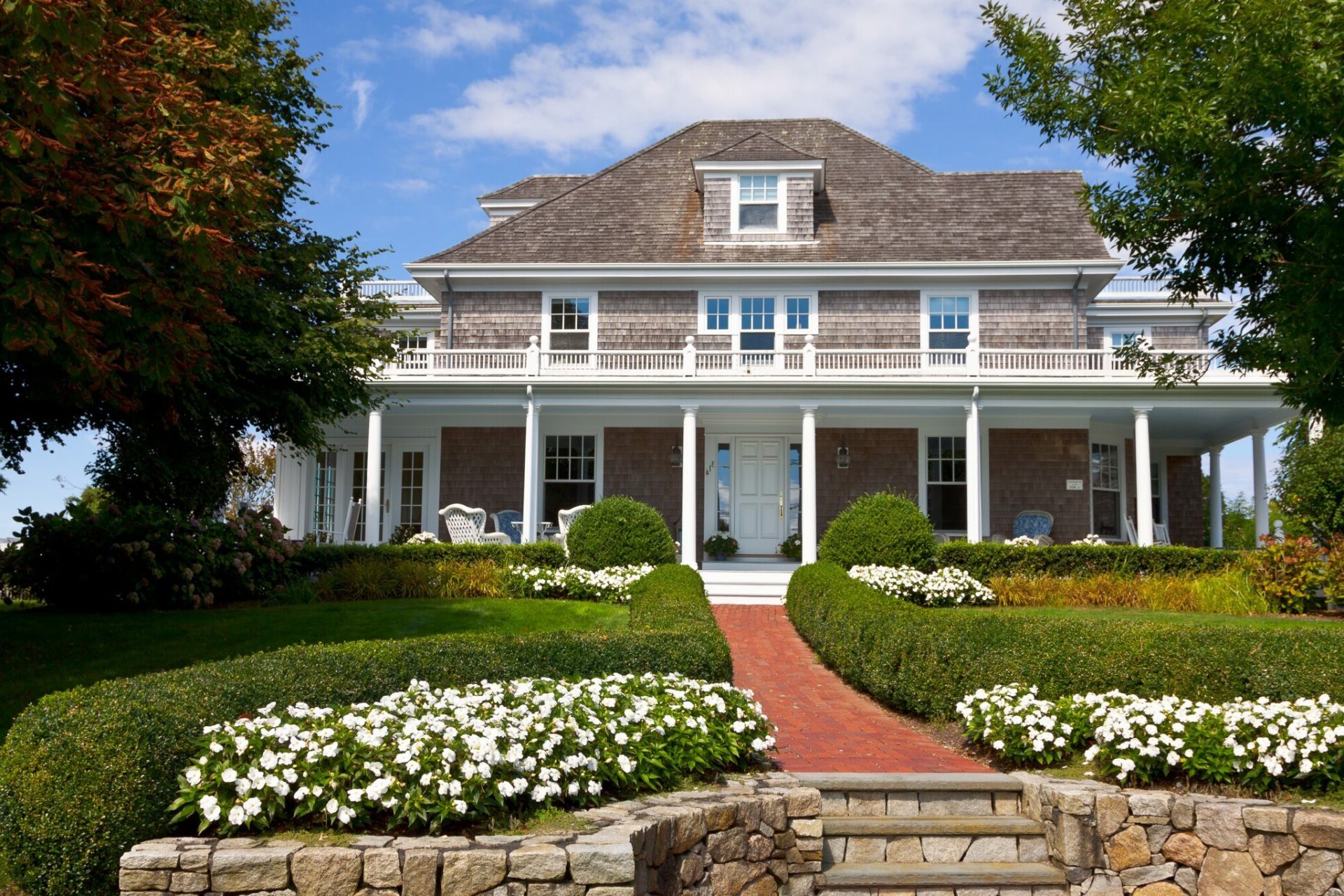 House with green lawn and brick walkway