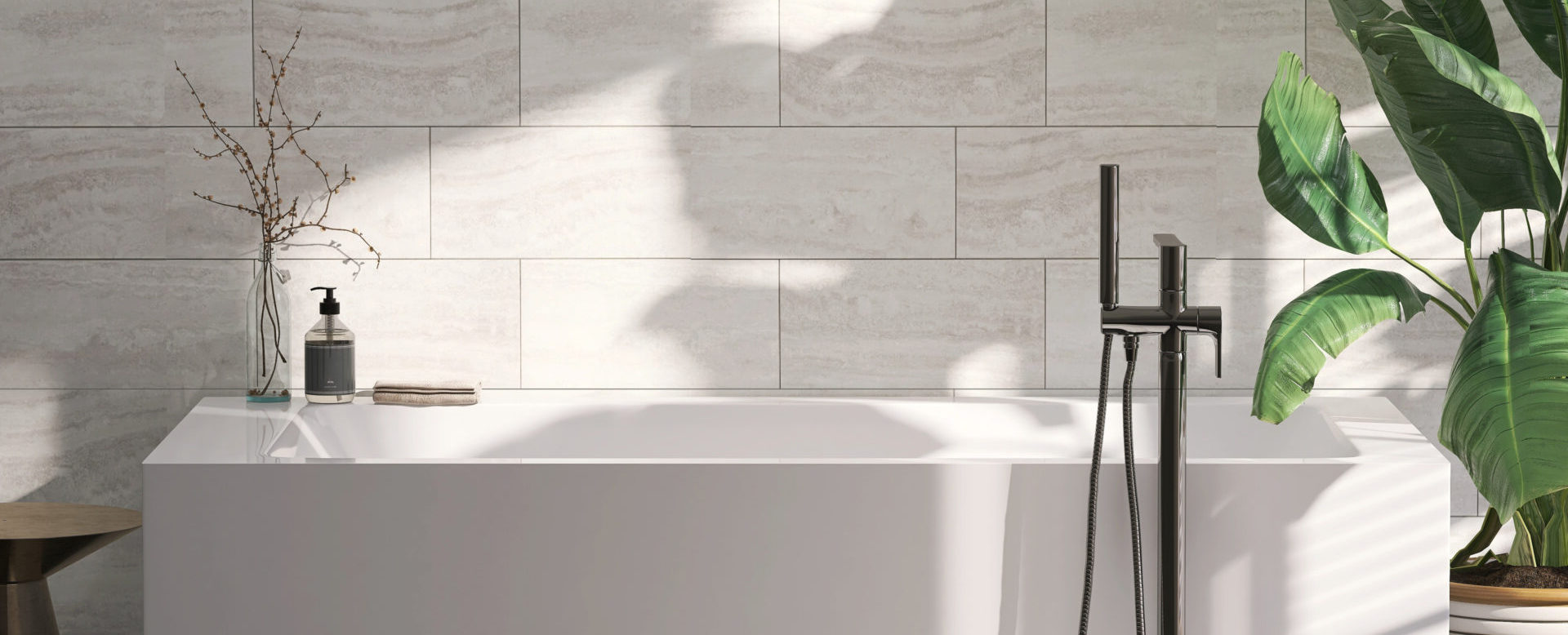 Modern bathtub in bathroom with plants and natural light