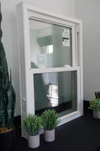 Champion Windows vinyl model standing next to potted plants