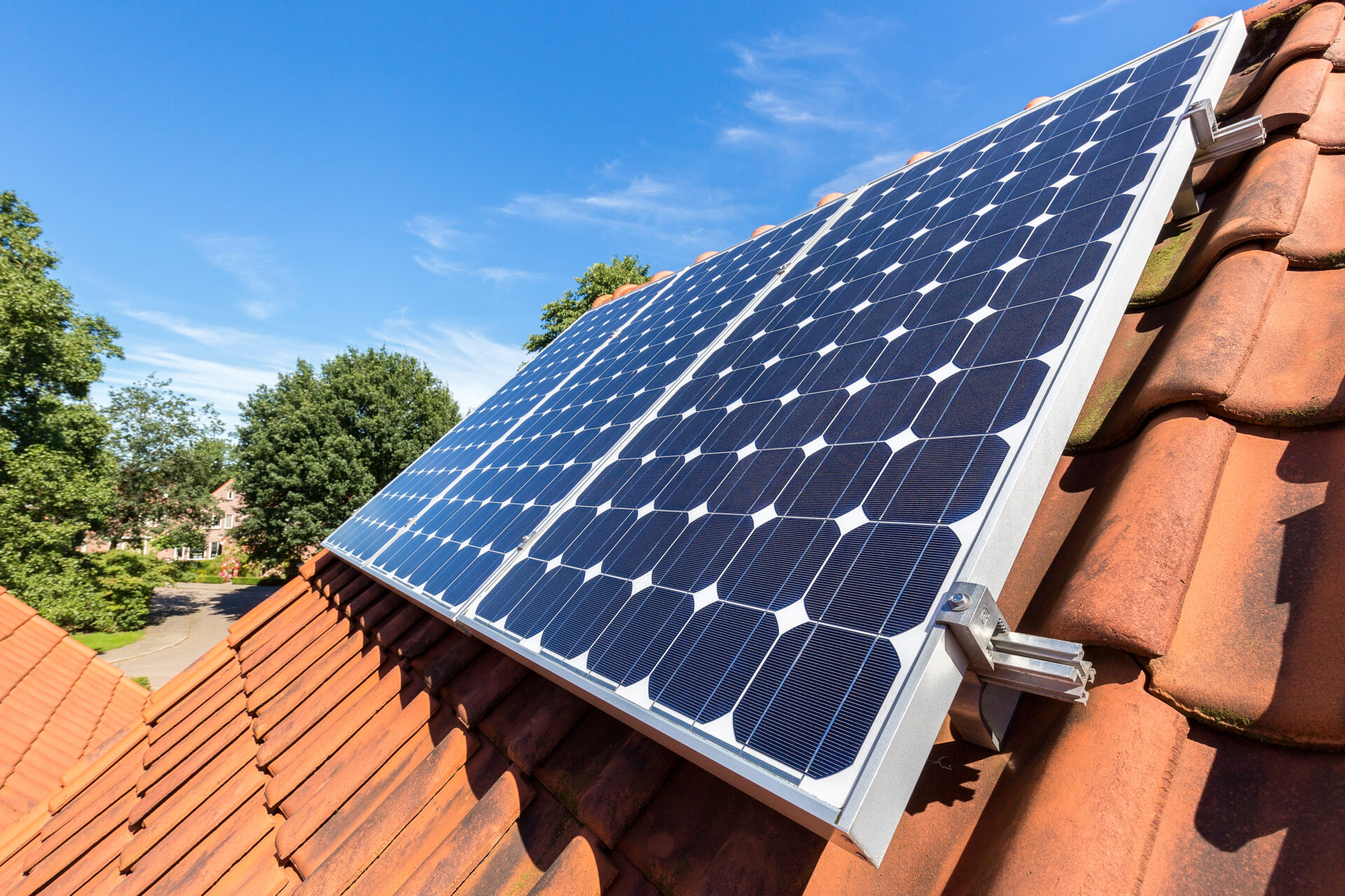 Row of blue solar panels on orange roof
