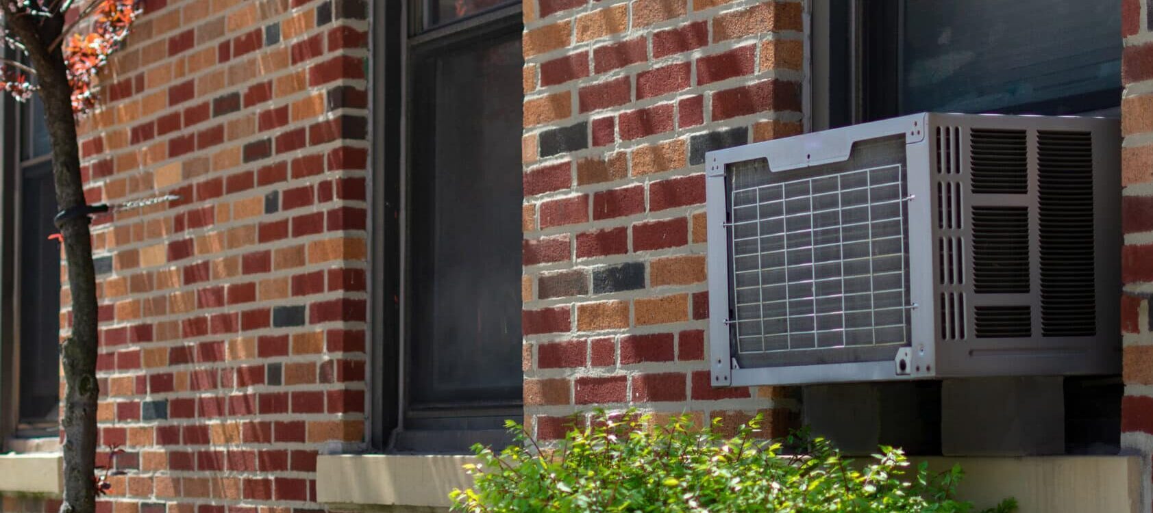 outside of a building with an AC unit in a window