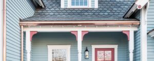 Blue house with copper half-round gutters.