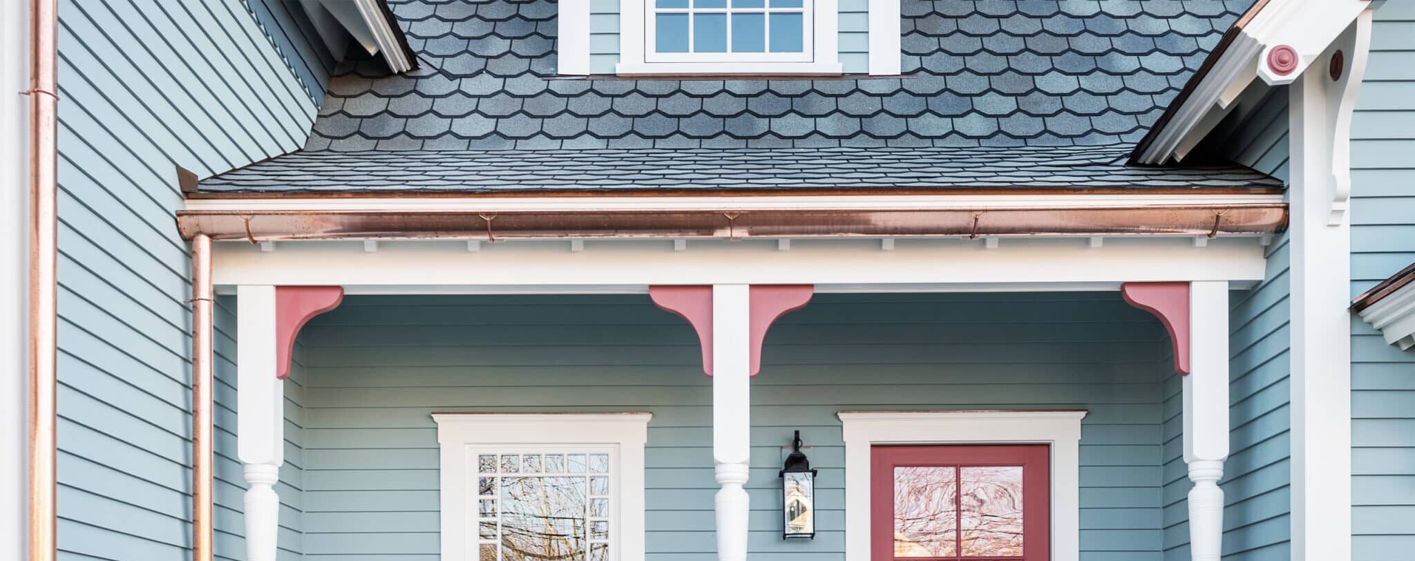 Blue house with copper half-round gutters.