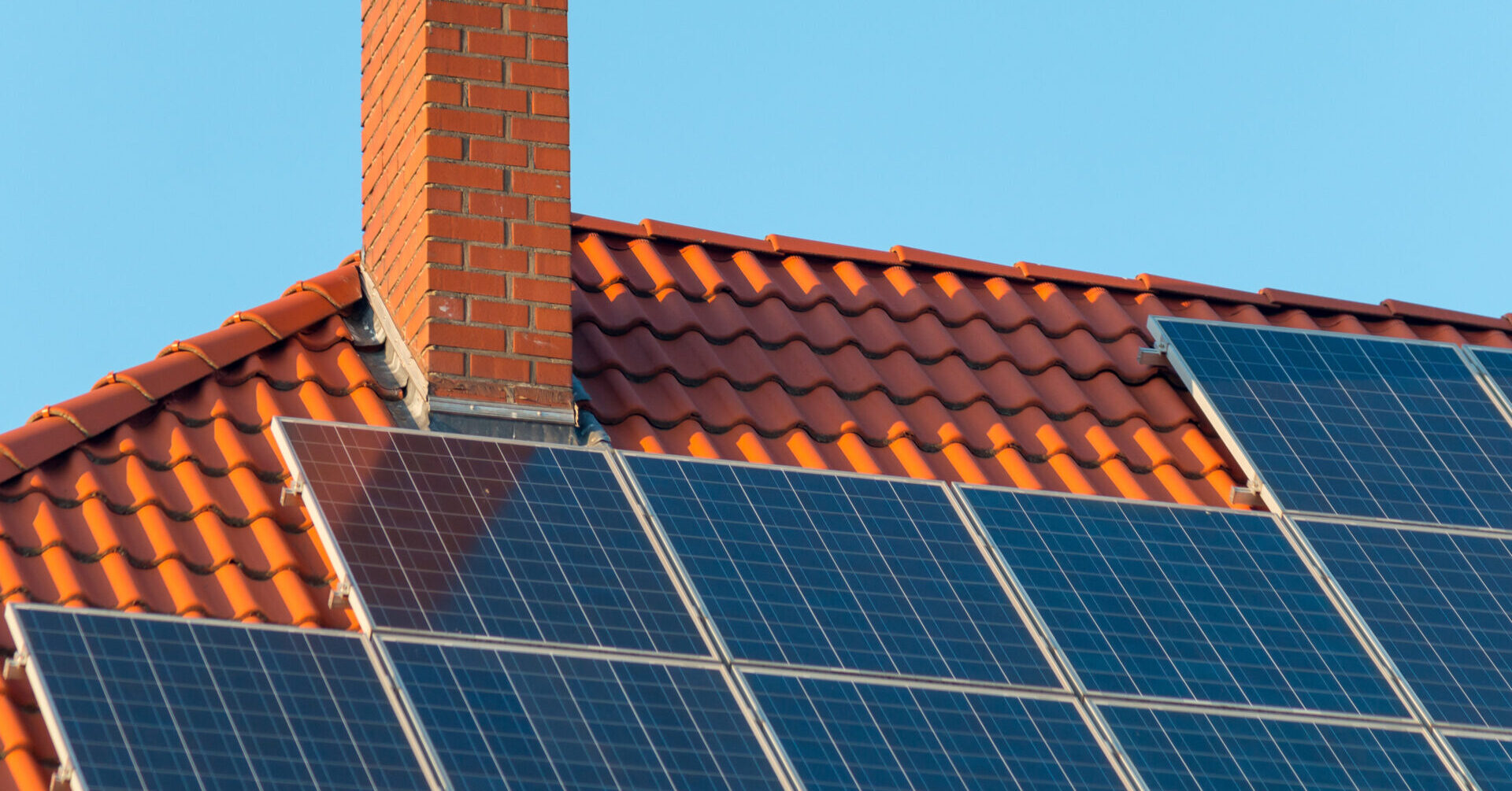 solar panel installation on a clay tile roof