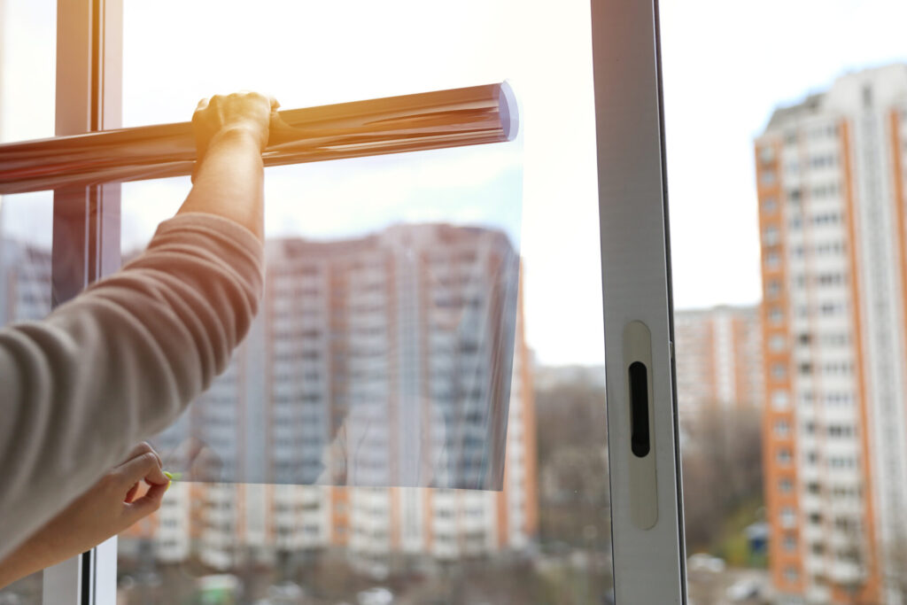 Person holding a roll of window film