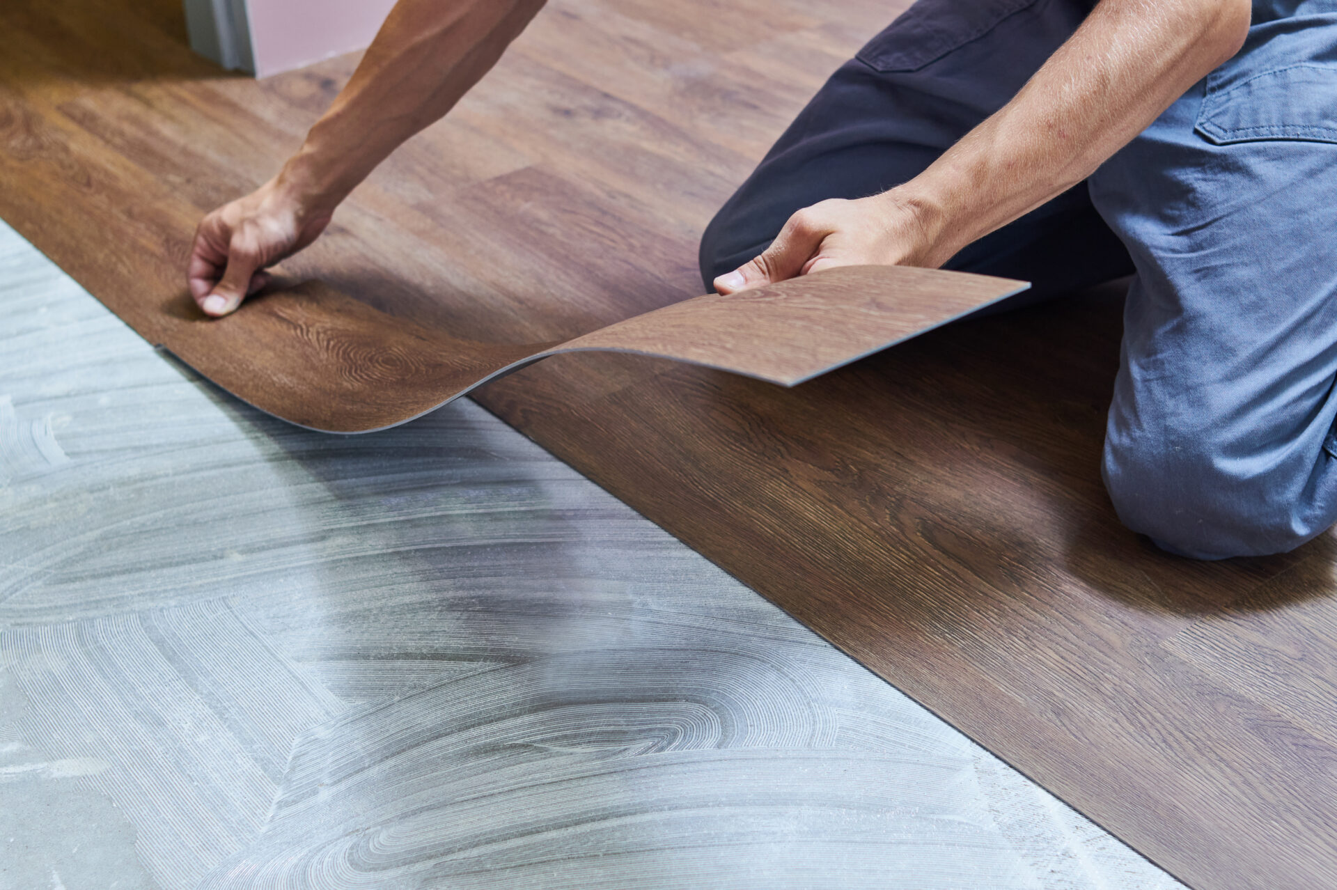 person installing vinyl flooring