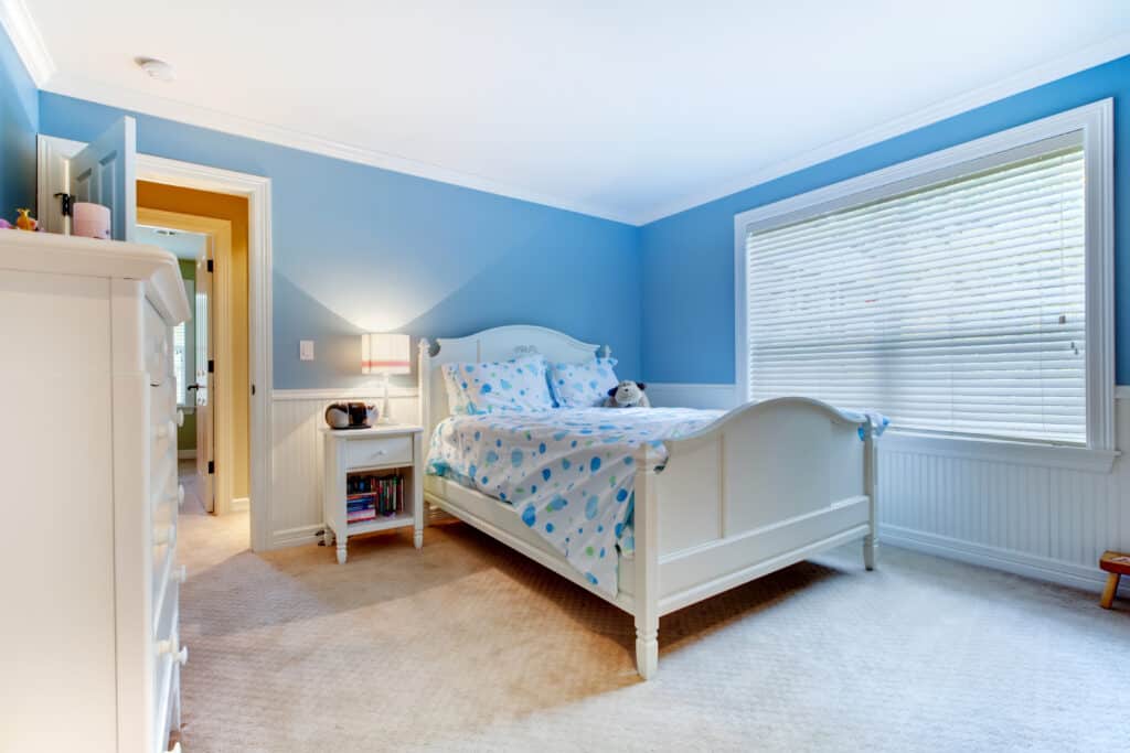 Blue kids bedroom interior with soft lamp lighting