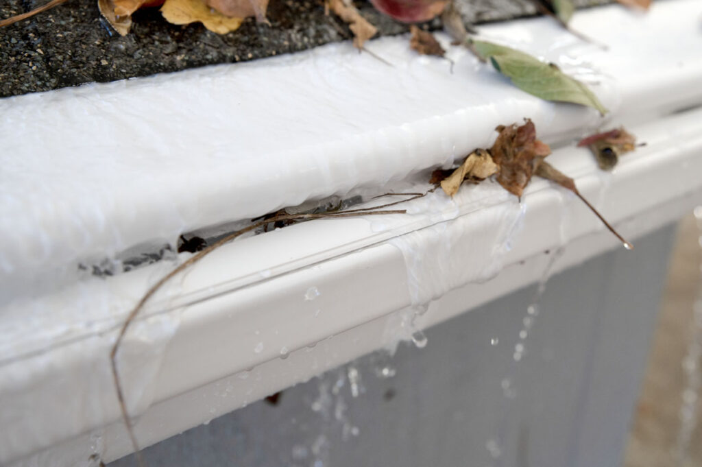 Testing a reverse-curve gutter guard with debris and rainfall