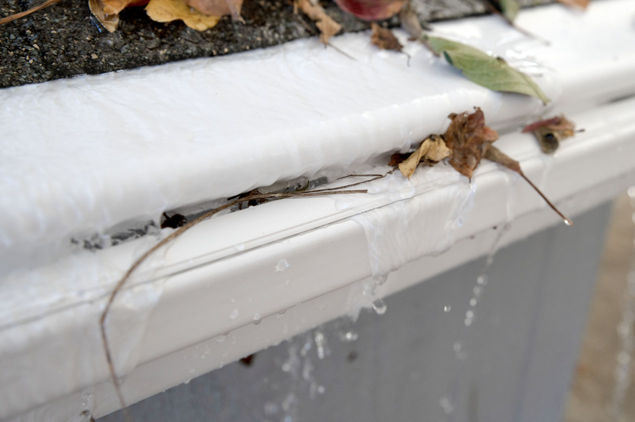 Testing a reverse-curve gutter guard with debris and rainfall