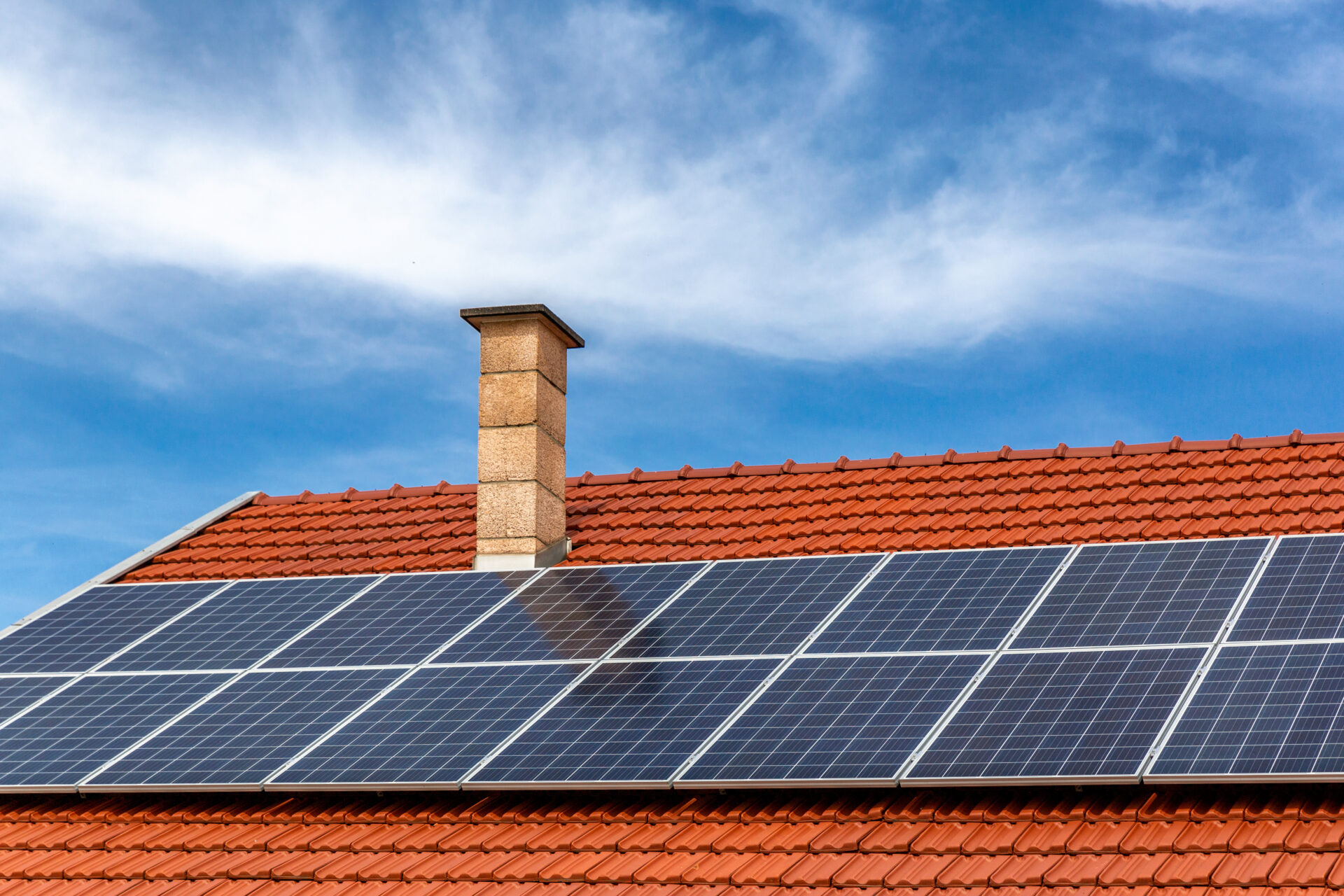 solar panel installation on a clay roof against a blue sky