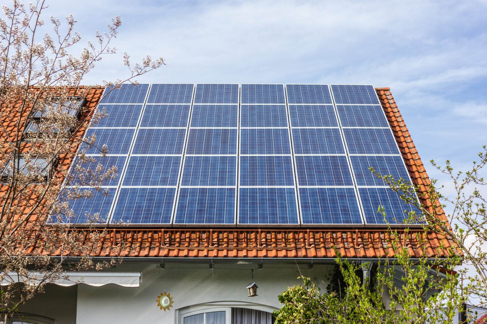 house with solar panels on rooftop at