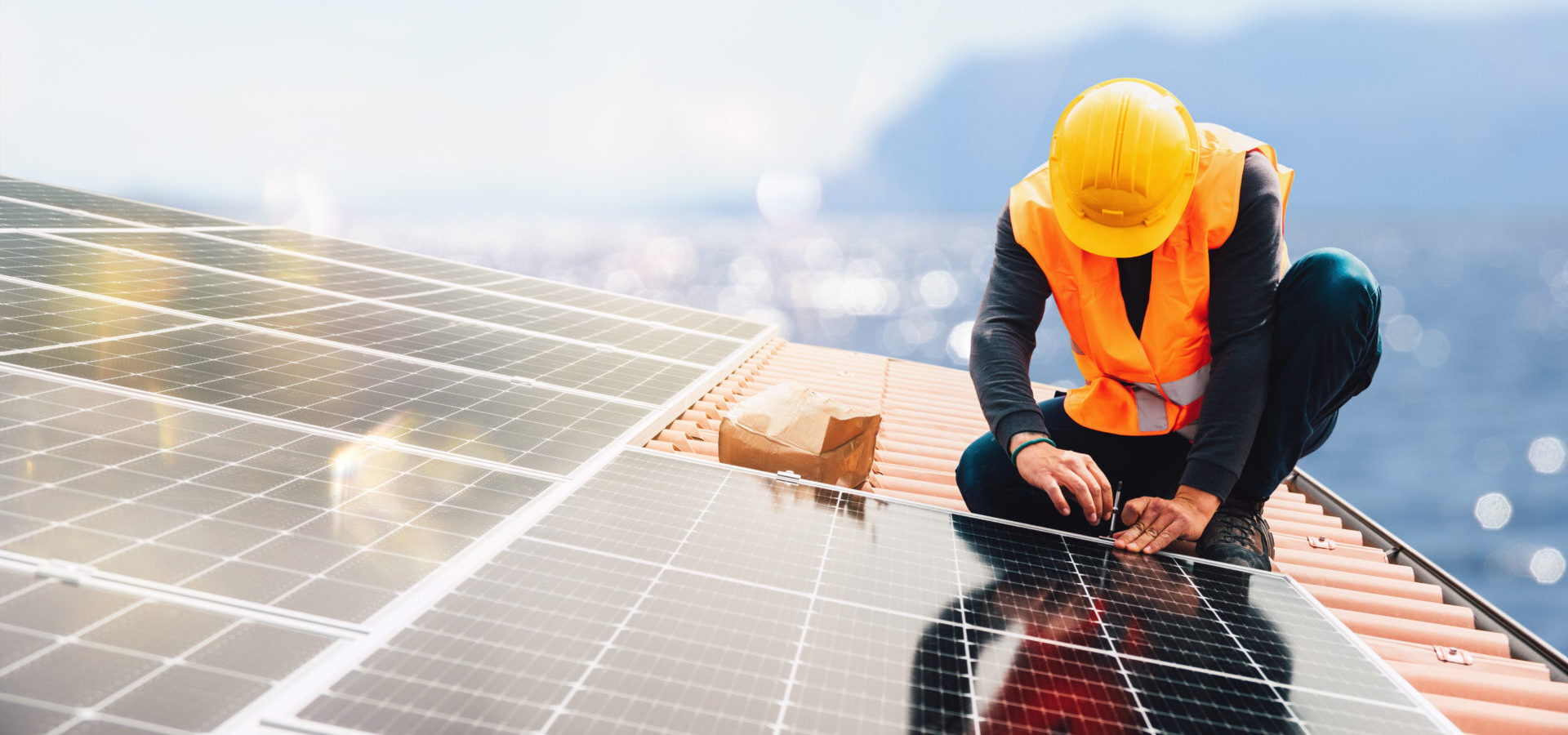 electrician installing solar panel system on a roof