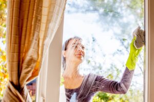woman cleaning the exterior of a window