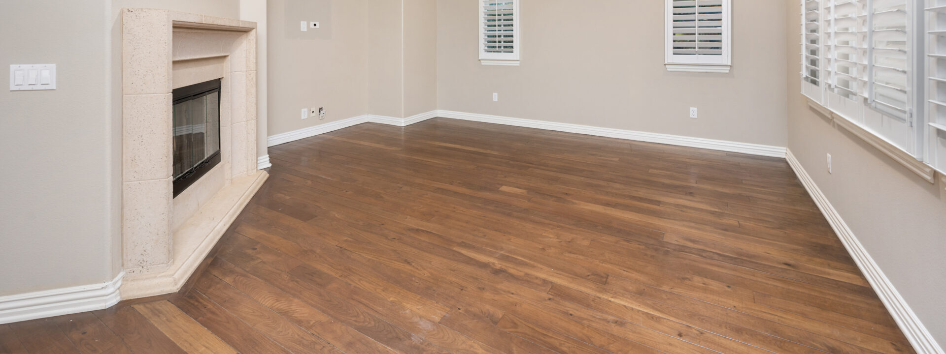 An empty room in a house with hardwood floors