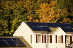 solar panel installed on the house roof with autumn trees