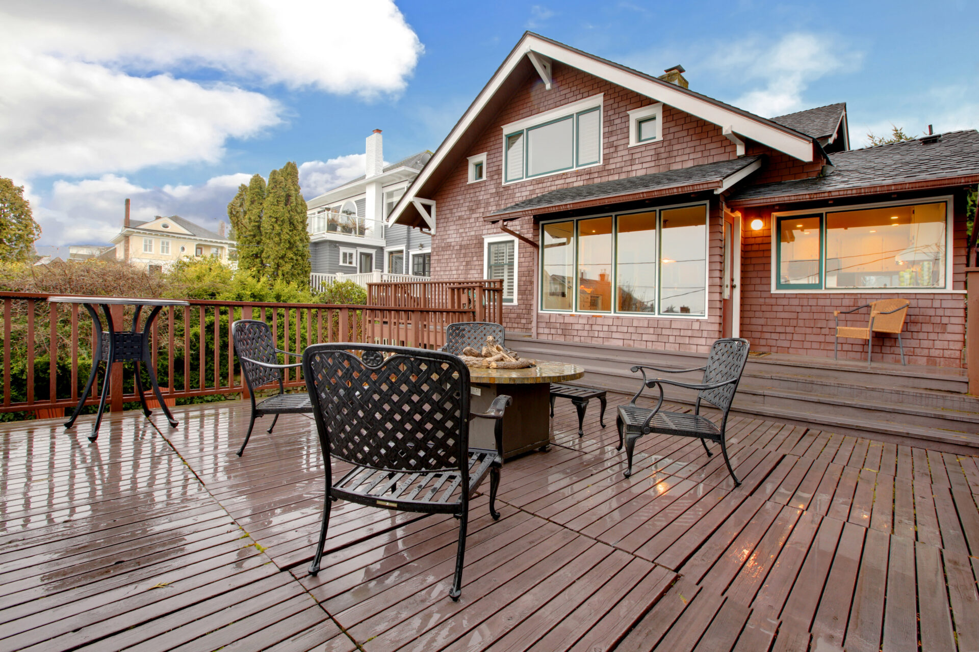 Large brown house with cedar siding and a back deck