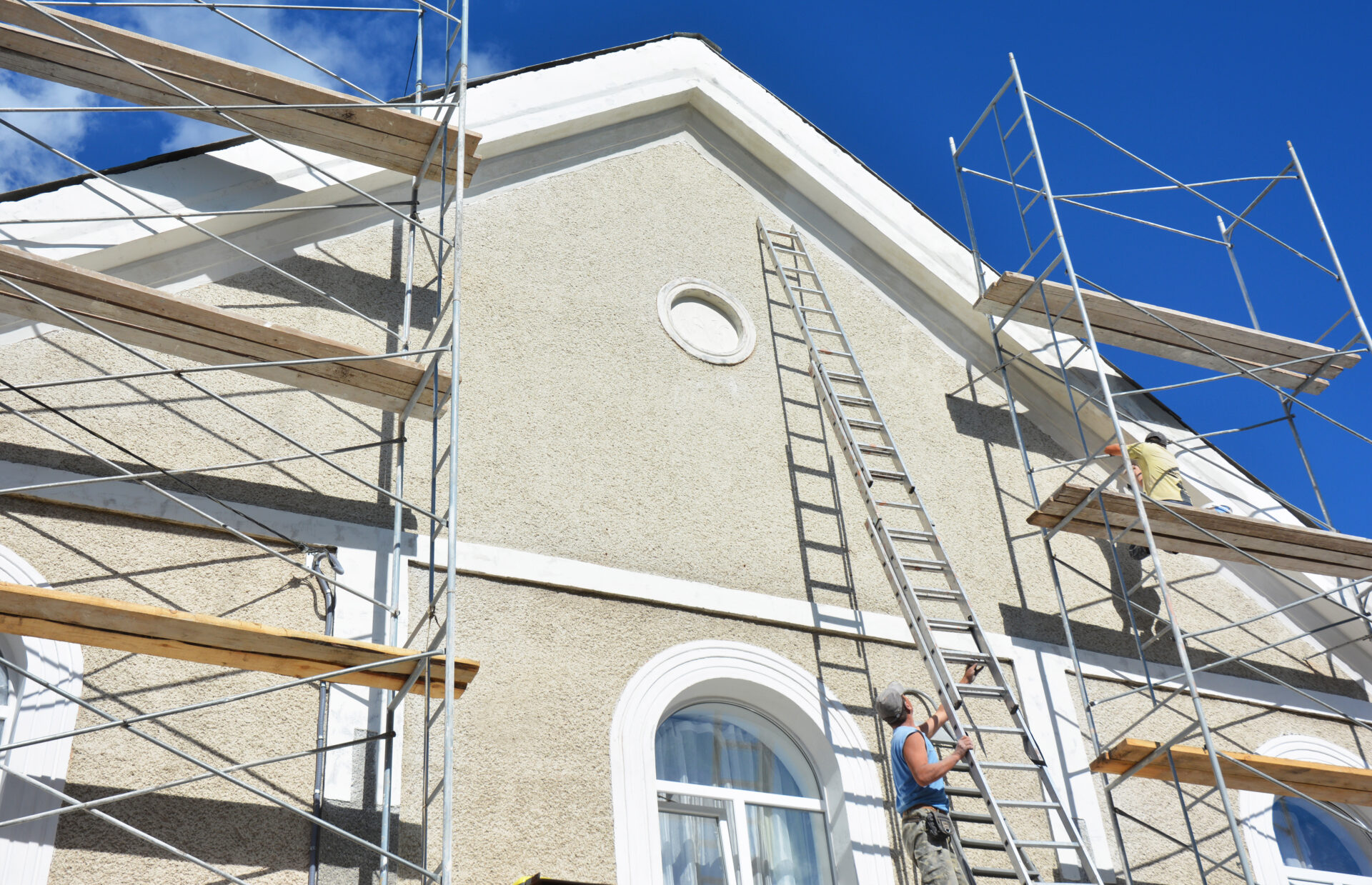 Scaffolding against a house during a stucco repair project