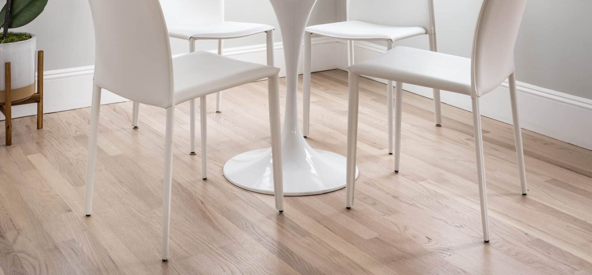 apartment interior with wooden floors and a dining table and chairs