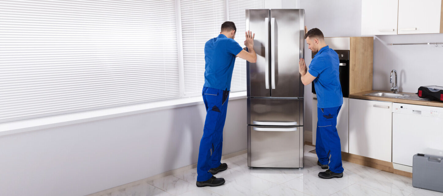 2 movers moving a refrigerator