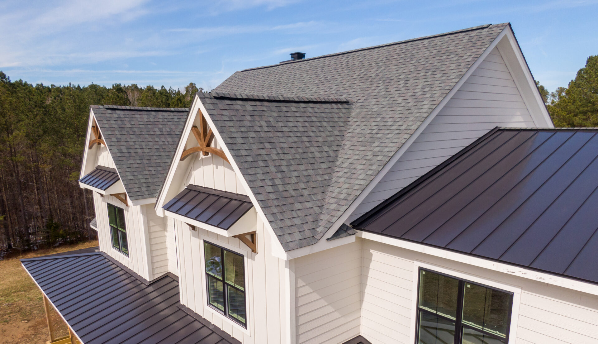 House with both metal and asphalt roofing