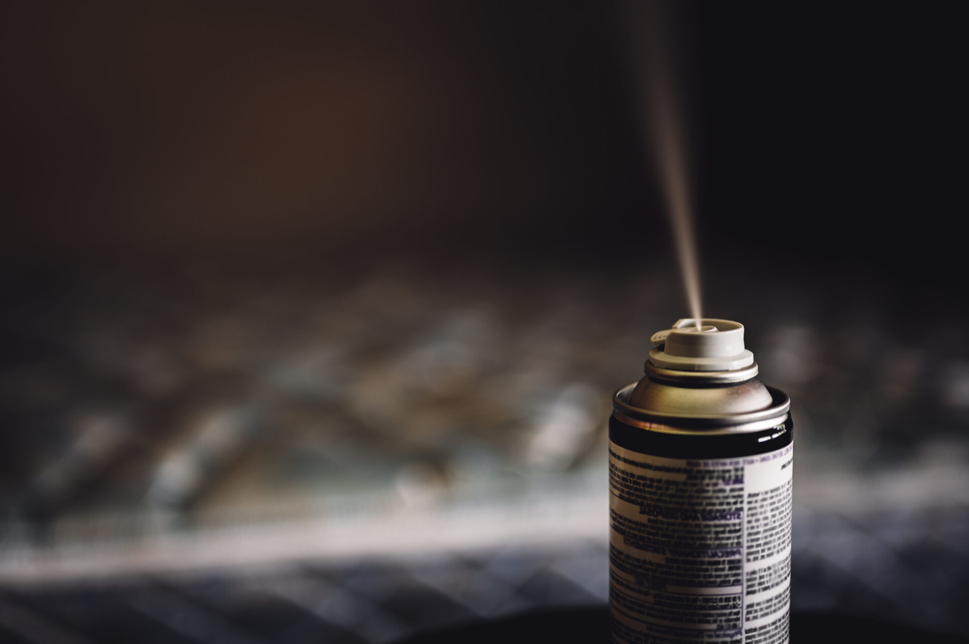 Active spray bottle spraying pesticide chemicals into the air