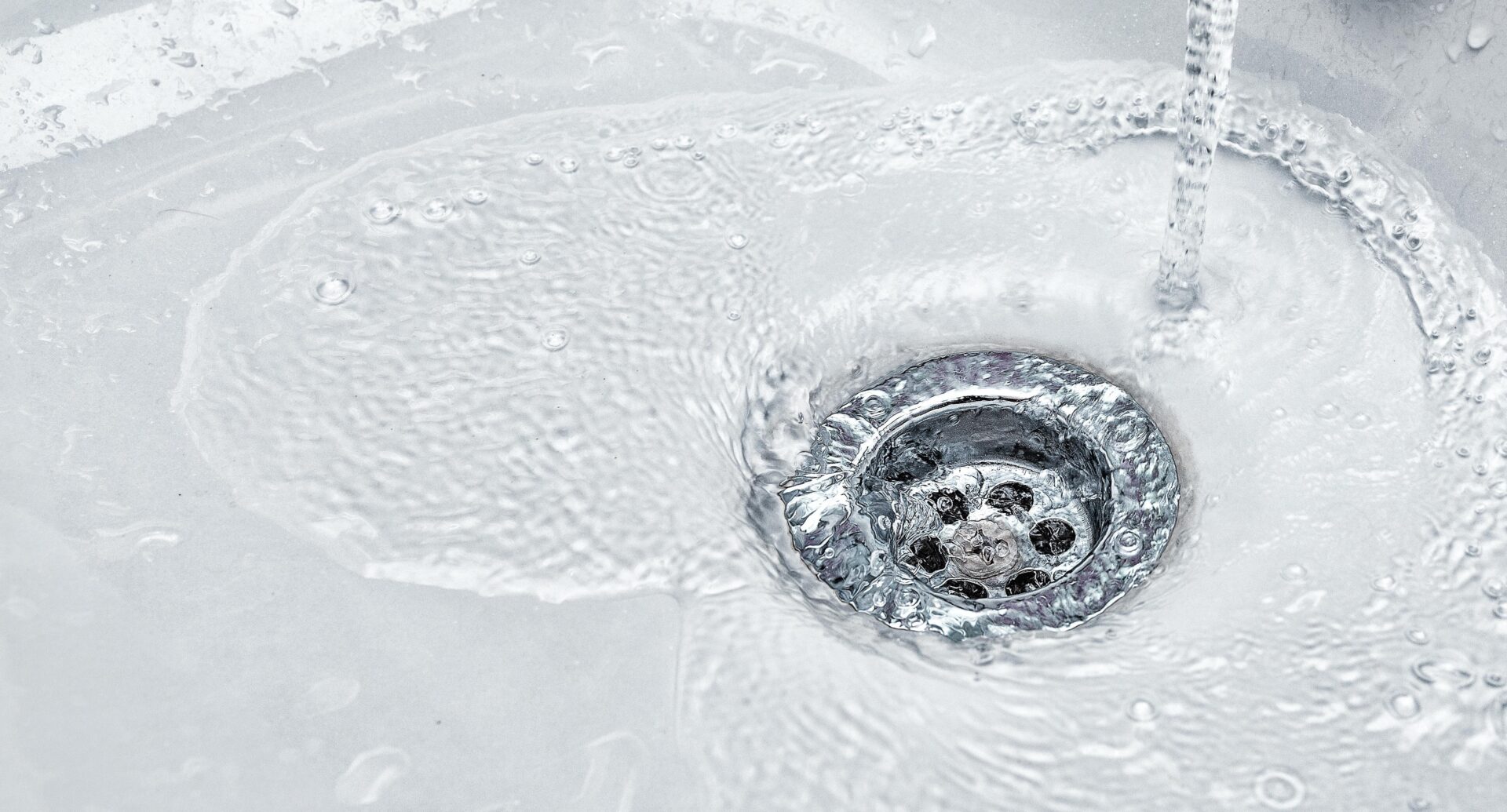 water running down the drain in a kitchen sink