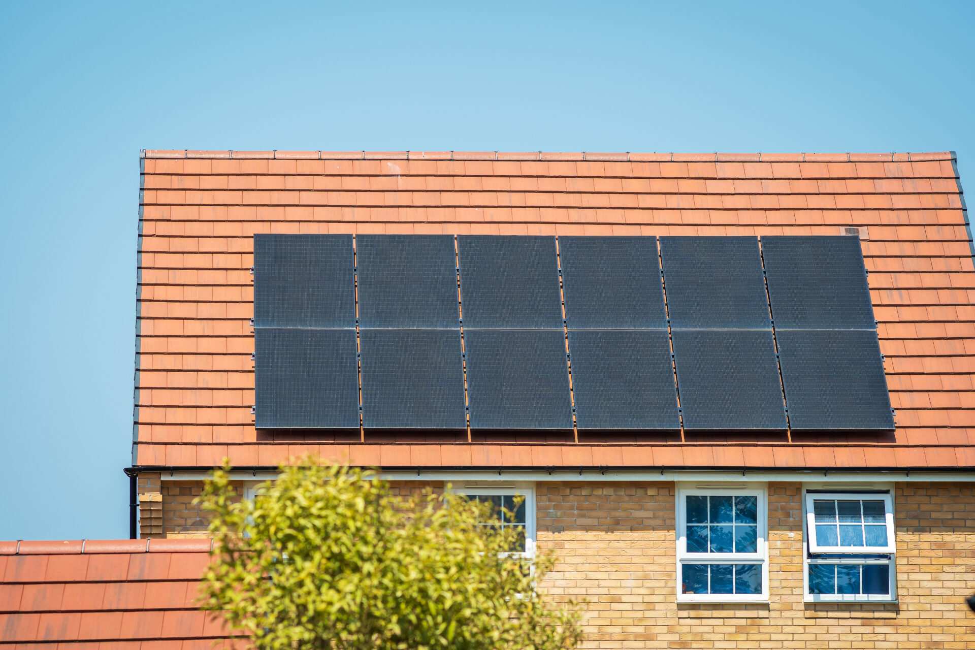 black solar panels on the roof of a new house