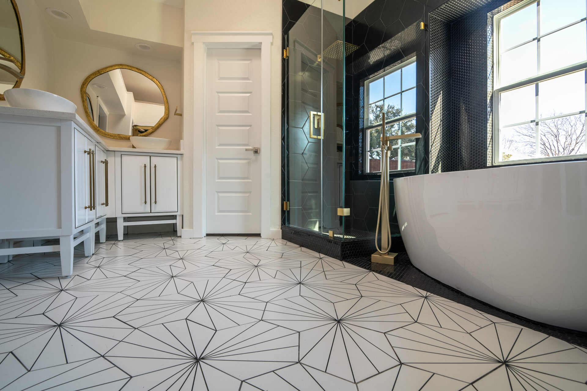 Black and white mid-century modern bathroom with hexagon tiles.