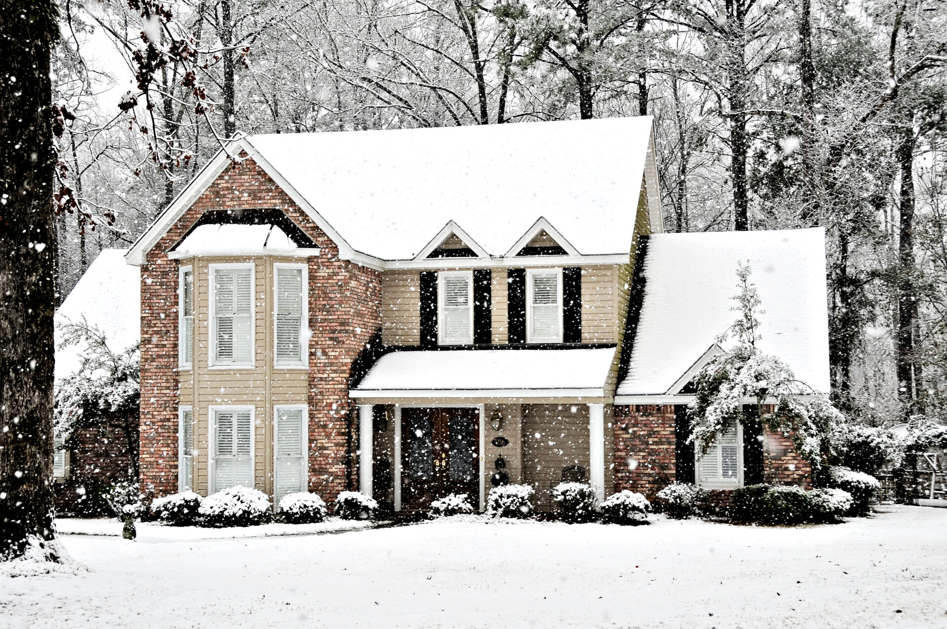 two story house on a snowy winter day