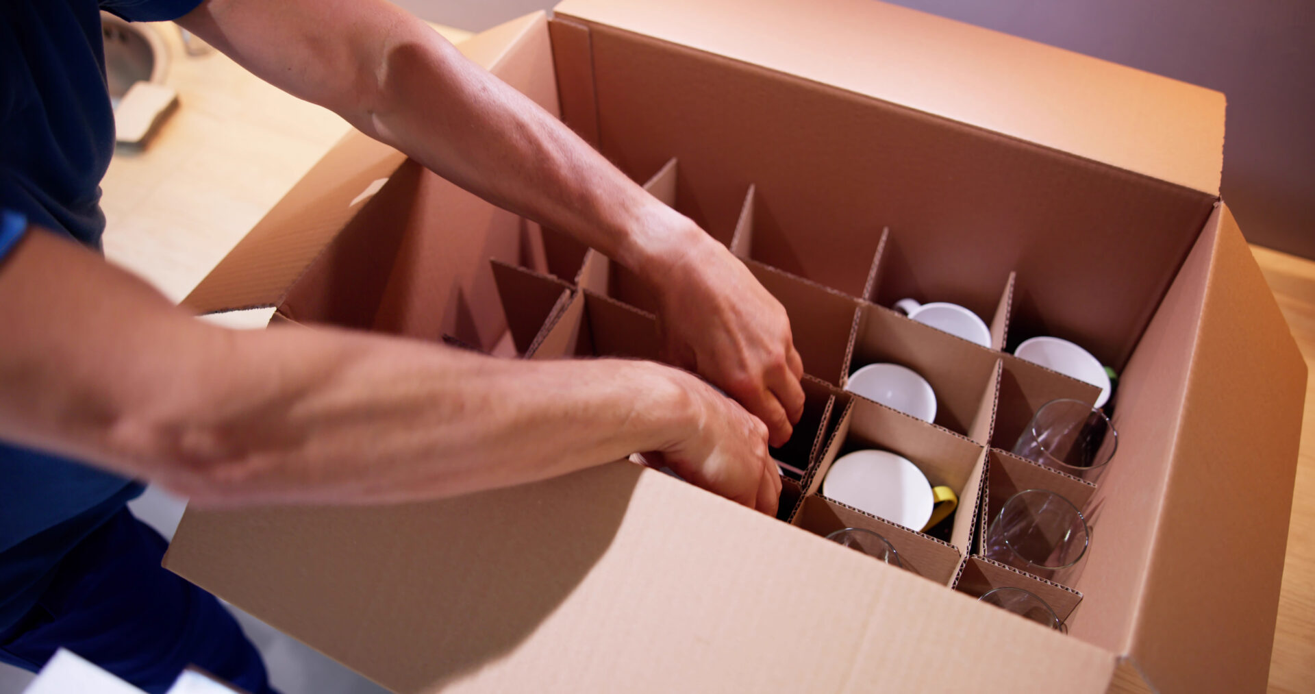 packing dishes into moving boxes