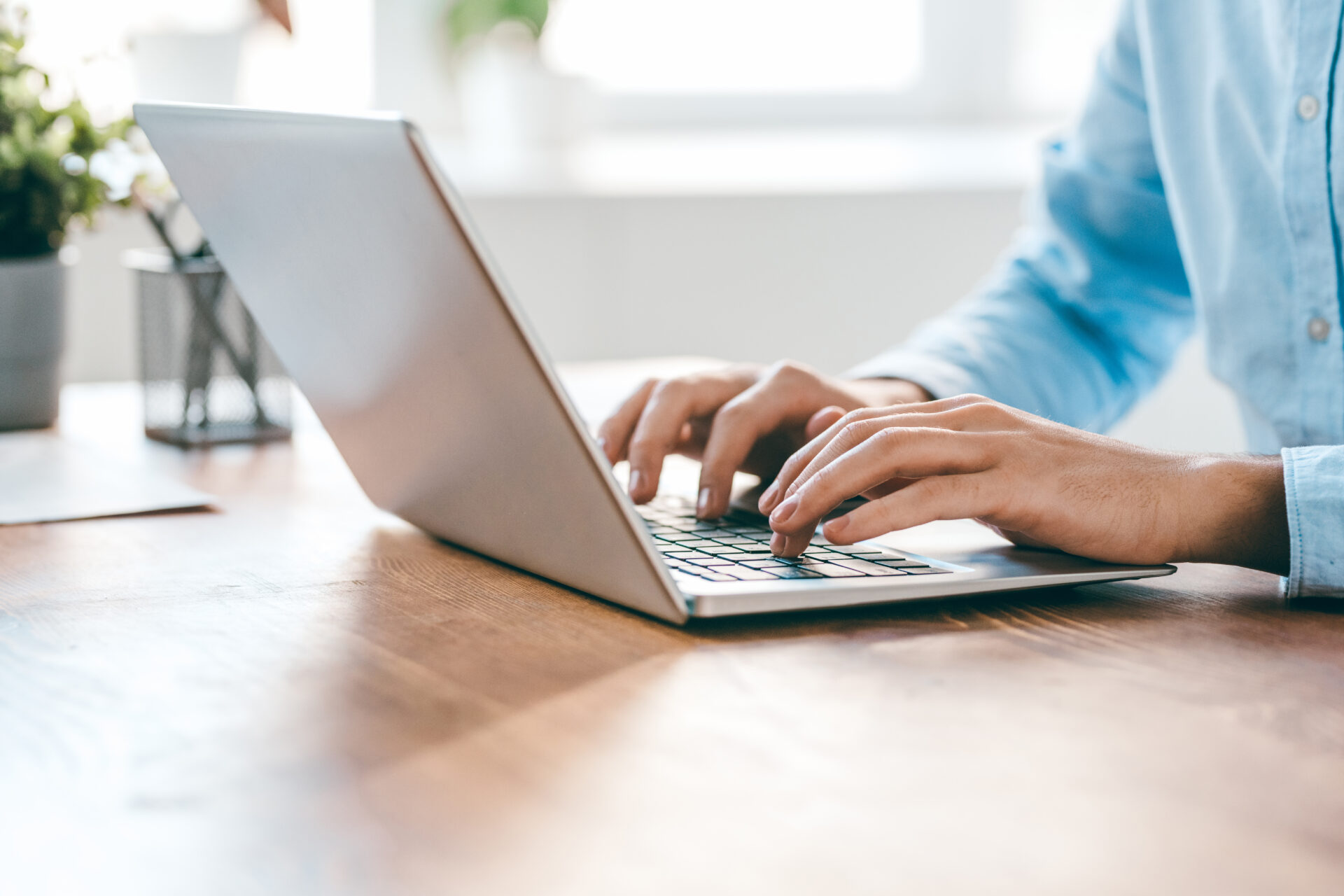 young man typing on laptop