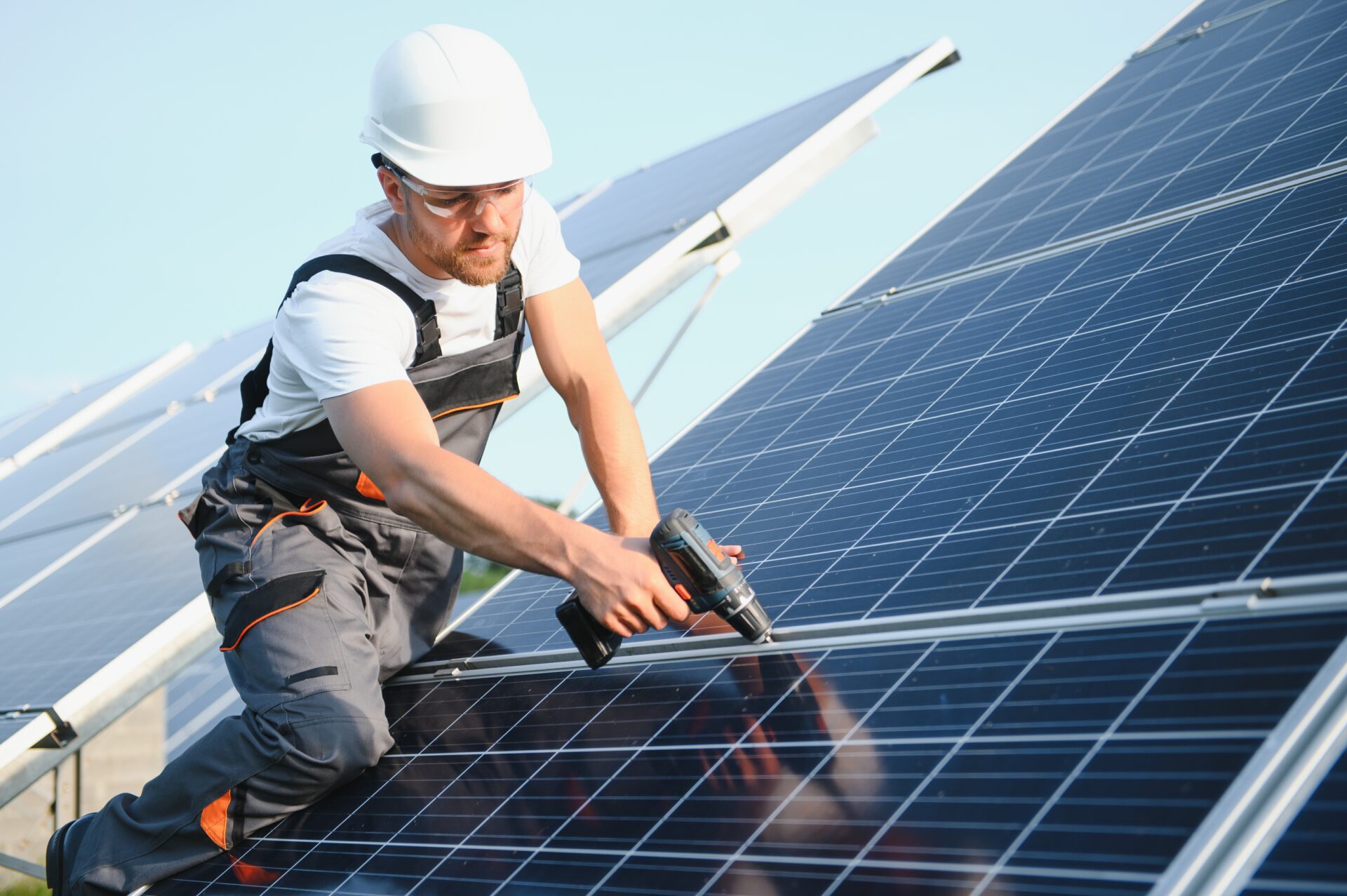 Worker installing solar panels outdoors