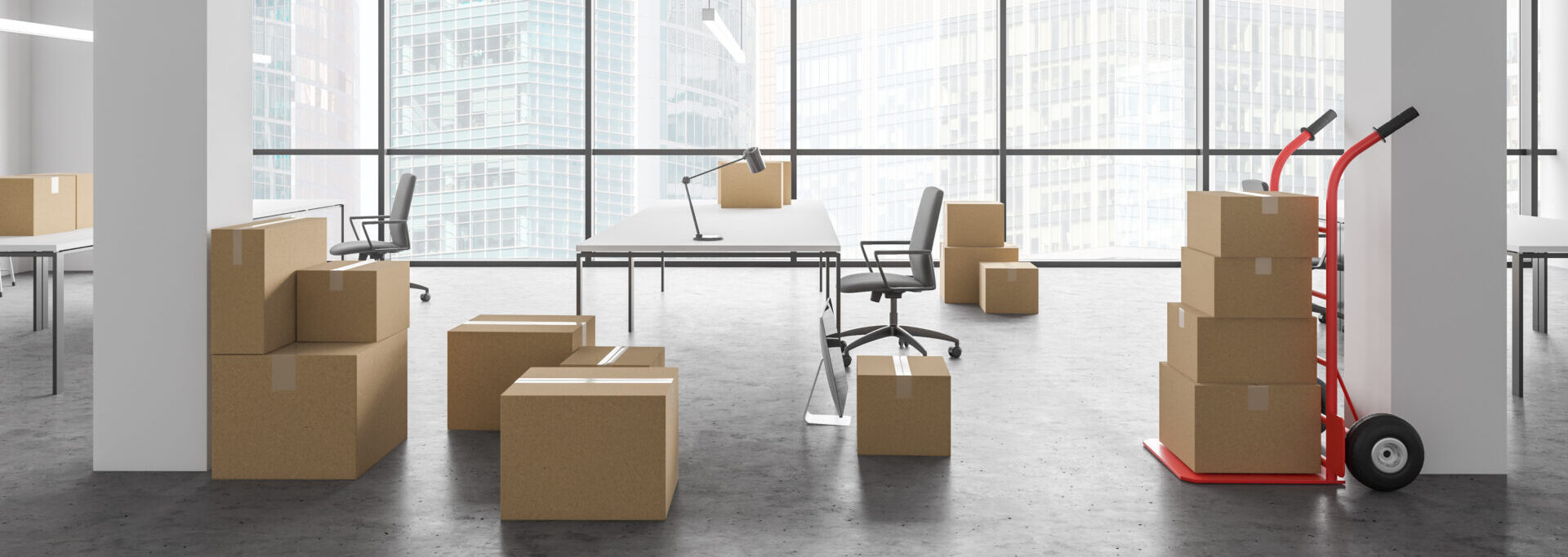 Cardboard boxes with equipment in spacious white industrial style open space office interior