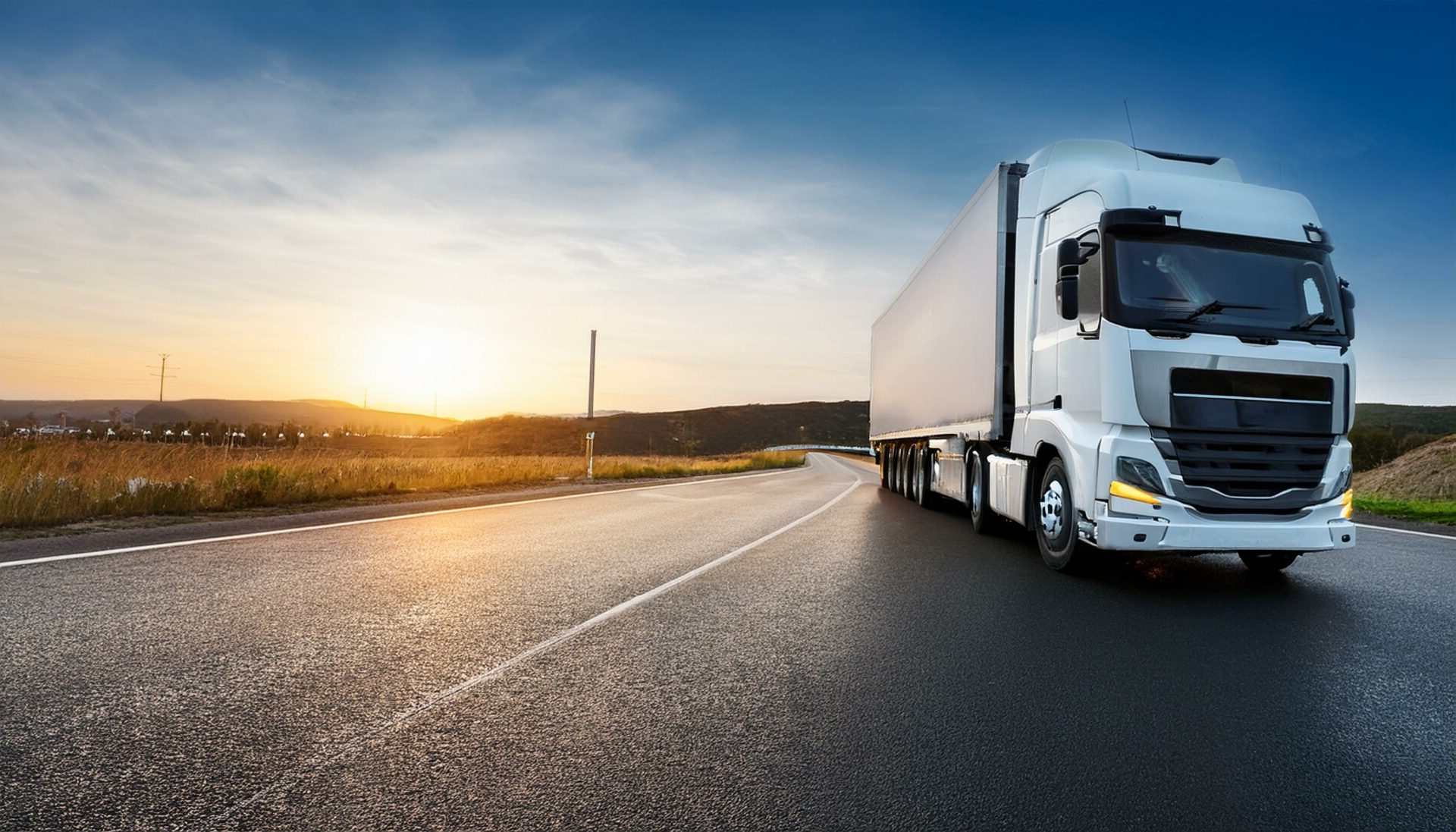 moving truck on the road during sunset