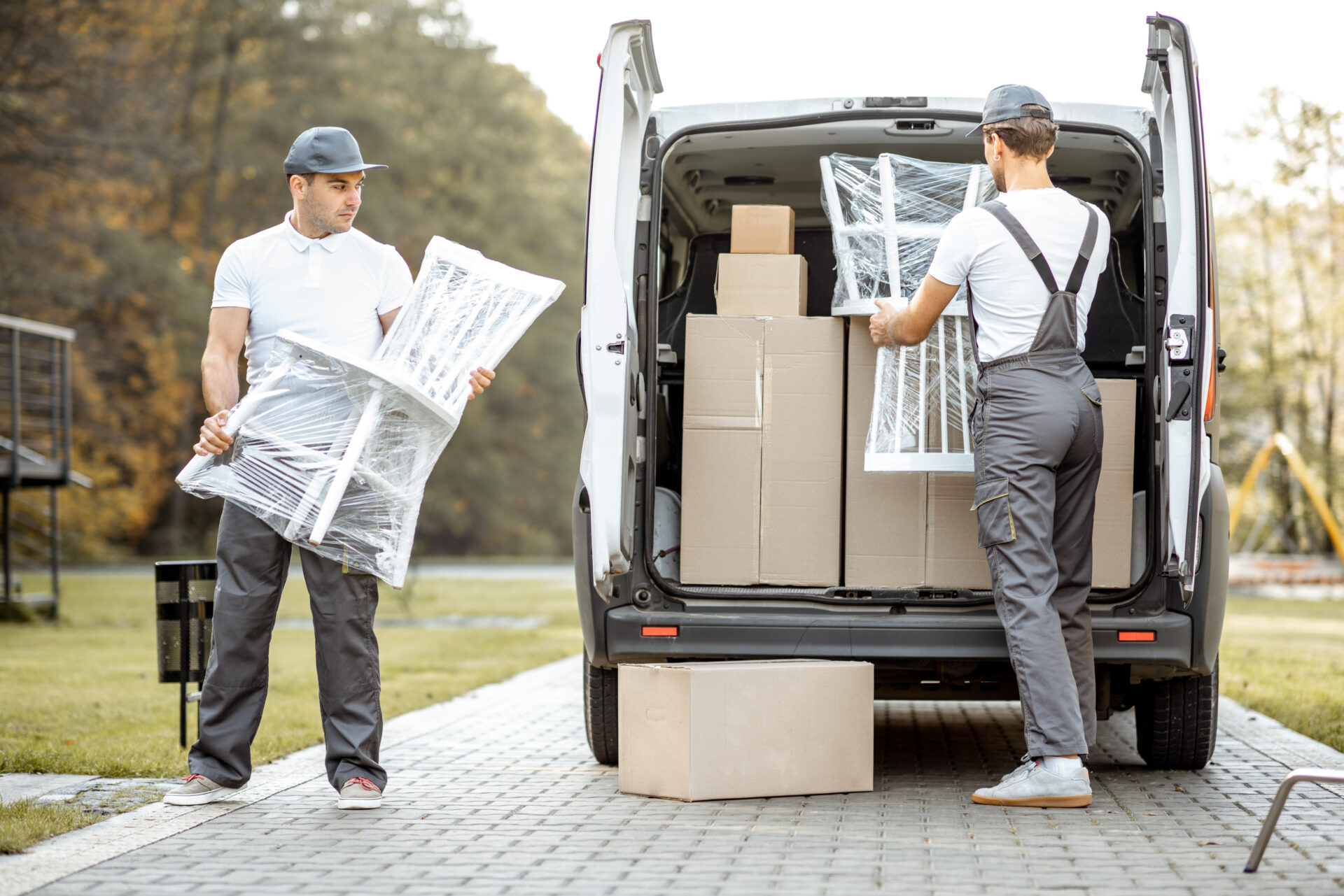 movers loading a truck with furniture and moving boxes