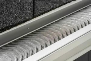 Newly installed fine mesh gutter guard on a roof.