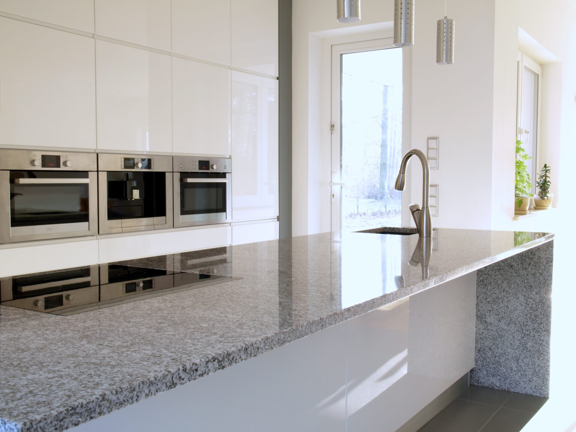 Minimalist modern kitchen with buil-in appliances and induction hob