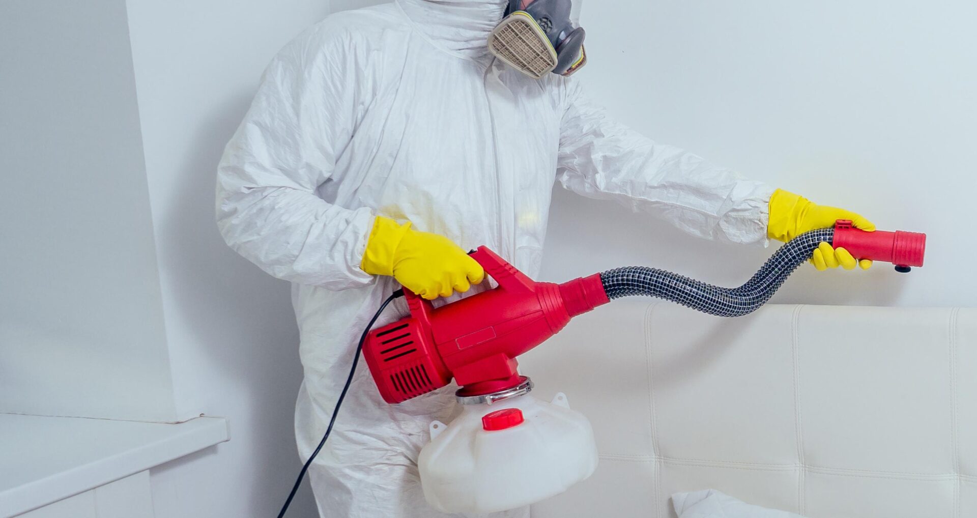 bed bug exterminator treating the bed with special equipment