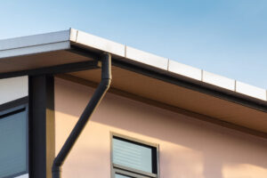 Gutter system and downspout on a modern house.