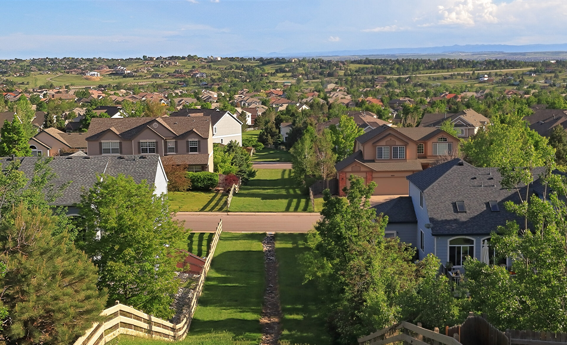 Panoramic view of suburban homes in Centennial, Colorado, showcasing lush greenery and residential living in the Denver metro area.