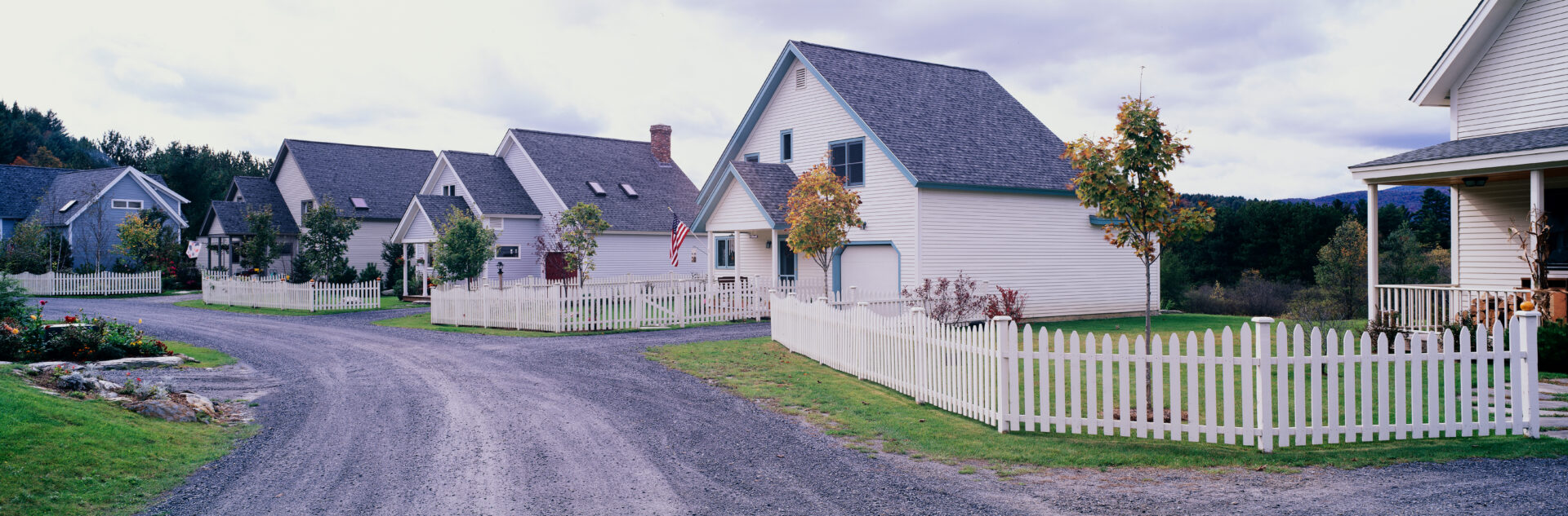 Neighborhood homes and picket fence in Stowe, VT.