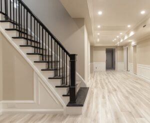 Staircase leading to brightly lit finished basement.