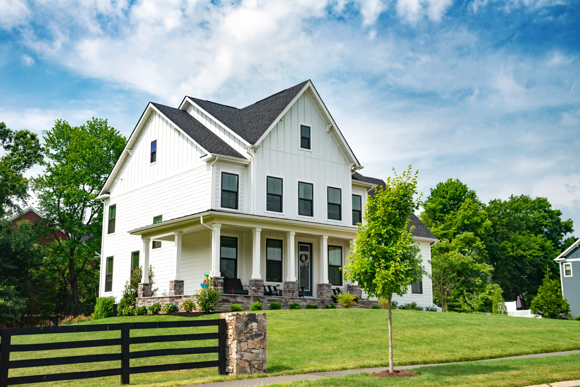 Landscape with a large country house. Large mowed lawn and blue sky.